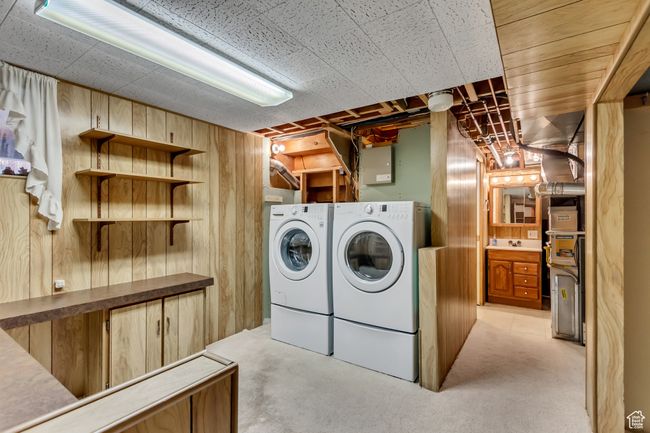 Laundry room with washer and dryer, wood walls, and laundry area | Image 26