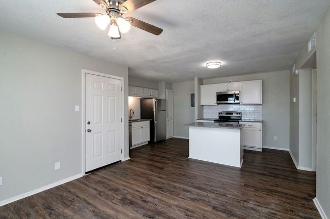 Kitchen with appliances with stainless steel finishes, dark wood-style flooring, and backsplash | Image 6