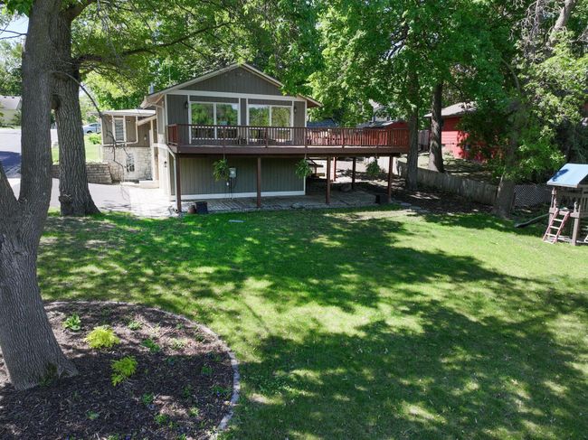 Large backyard leading to lake | Image 34