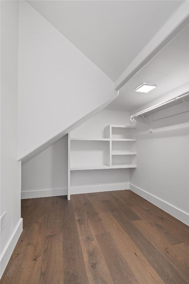 Walk in closet featuring wood finished floors | Image 13