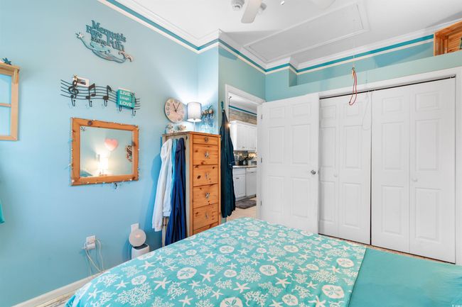 Bedroom with attic access, crown molding, a closet, and a ceiling fan | Image 18