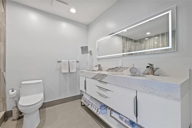 Touch mirror for on/off control. Modern vanity with plenty of storage | Image 45