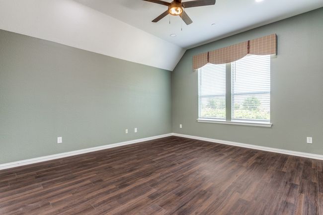 Generational Suite Bedroom featuring ceiling fan, baseboards, and raised ceiling | Image 19