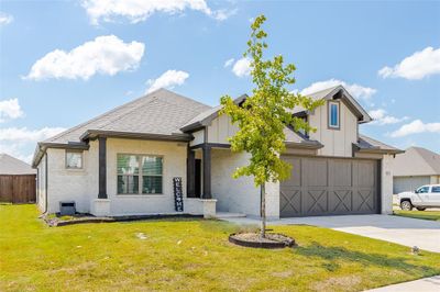 View of front of property featuring a front entry garage and front lawn | Image 2