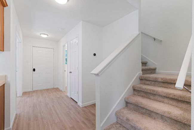 This two-level layout, with the main living area downstairs and bedrooms upstairs, creates a sense of privacy and separation between communal and personal spaces. | Image 18