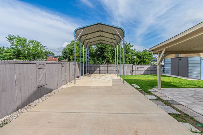 Fenced backyard featuring a carport | Image 30