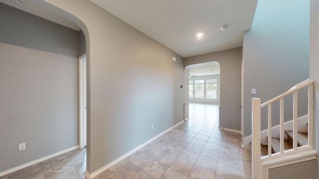 Corridor with arched walkways and baseboards | Image 7