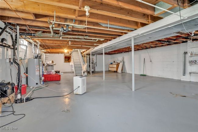 Unfinished basement with water heater and stairway | Image 22