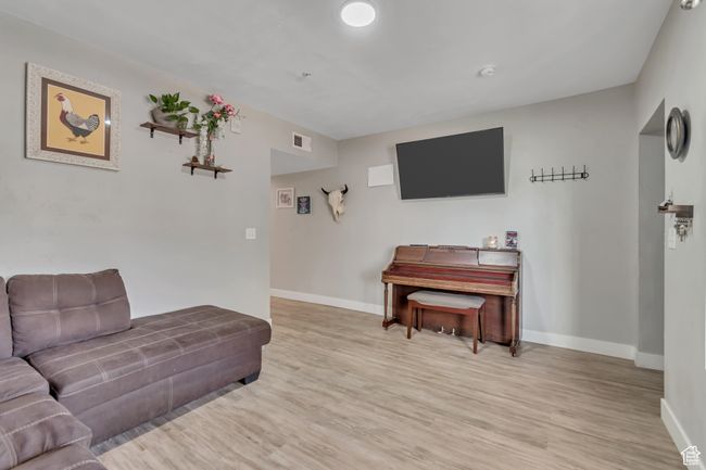 Living room with light wood-style floors | Image 6