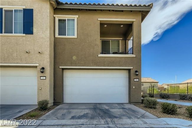 View of front of property with concrete driveway, a garage, and stucco siding | Image 22