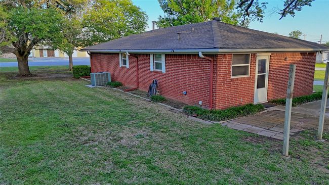 Back of house with a lawn, a shingled roof, and brick siding | Image 14