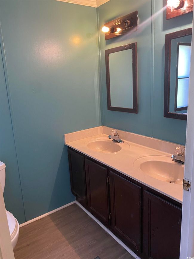 Bathroom with double vanity and wood finished floors | Image 23