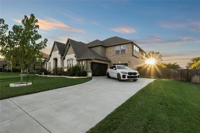 View of front facade with a garage and a lawn | Image 3