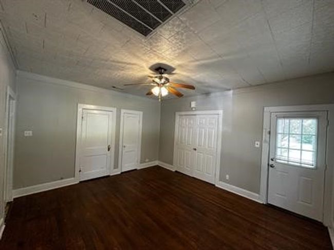 Entryway featuring a ceiling fan and wood finished floors | Image 4