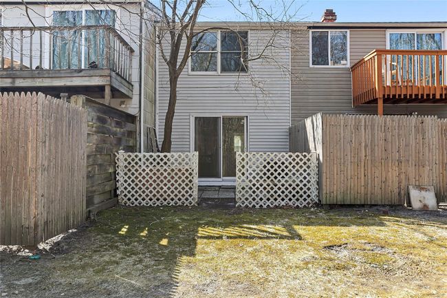 Back of house featuring a lawn, a chimney, and fence | Image 10