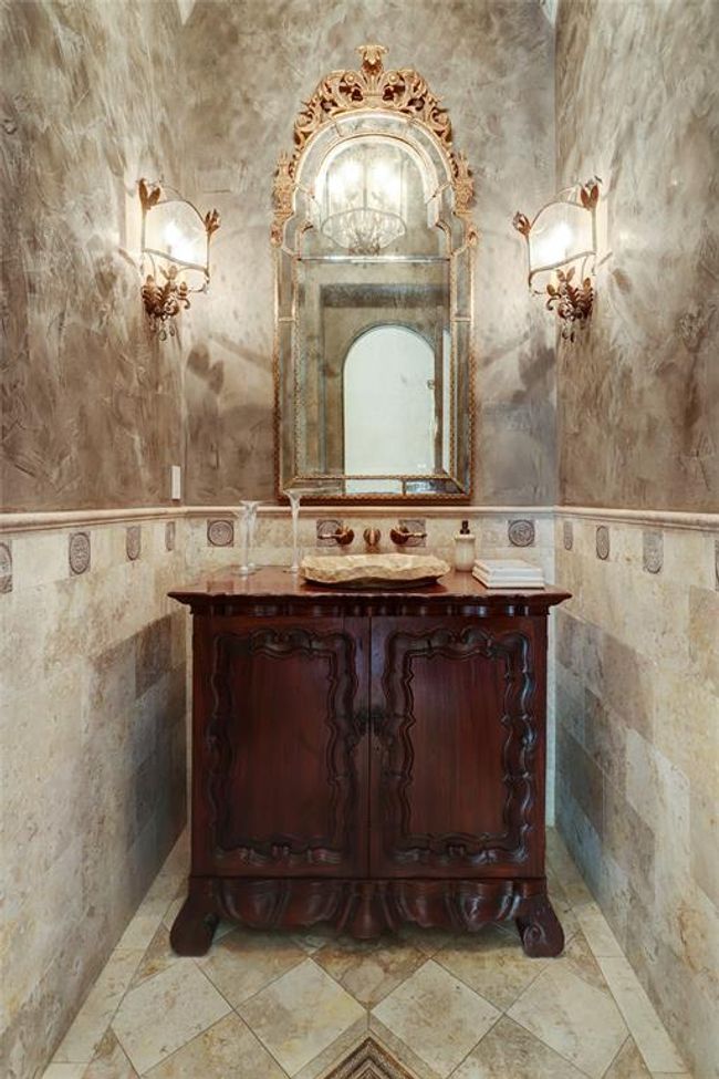Half bath located next formal living and bar. Barreled dome ceiling, stone sink, Walker Zanger tile, carved limestone and venetian plaster walls. Spectacular! | Image 18