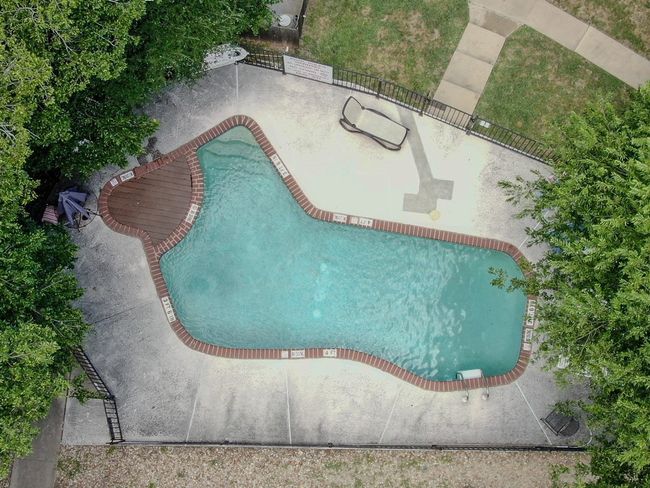 View of swimming pool with a patio | Image 4