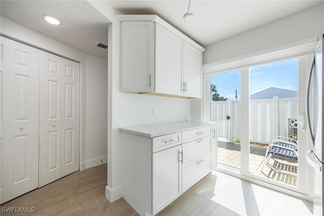 Kitchen breakfast bar, with sliding glass door to front patio. | Image 7