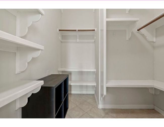 Spacious closet featuring light tile patterned floors | Image 15