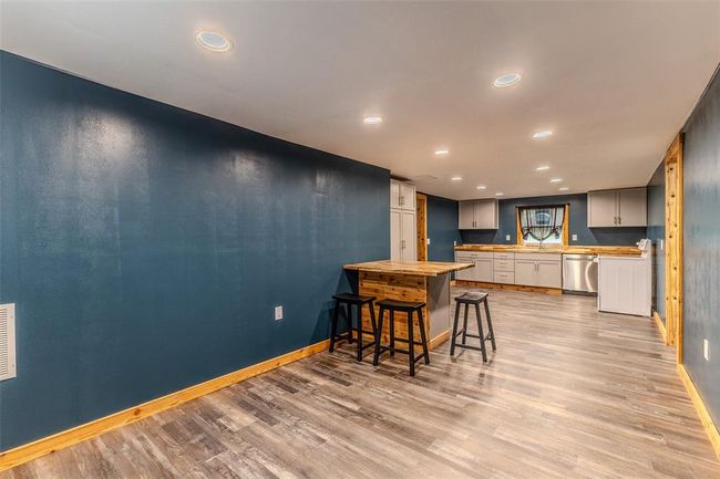 Kitchen with dishwasher, baseboards, light wood-style flooring, recessed lighting, and a sink | Image 16