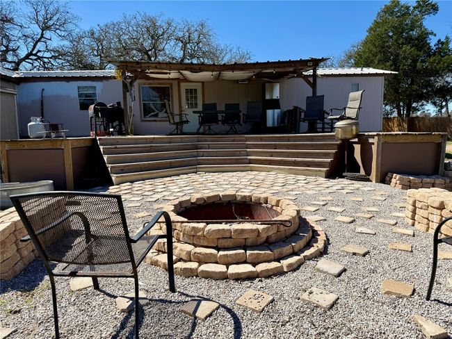 Back of property with a patio area and an outdoor fire pit | Image 8