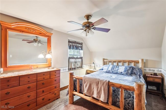 Bedroom featuring lofted ceiling, carpet floors, and ceiling fan | Image 17