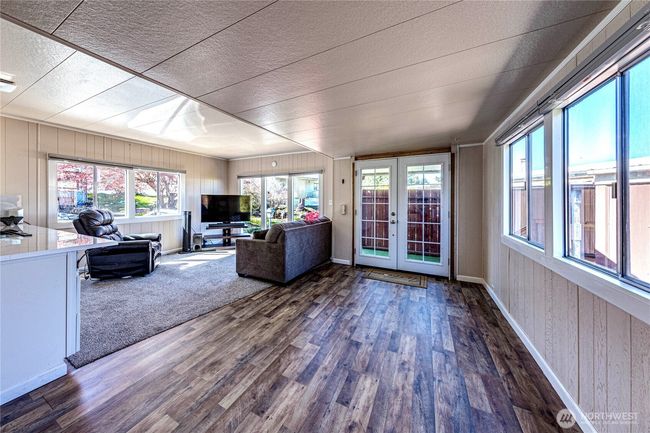The living room area leading to the front deck. | Image 8