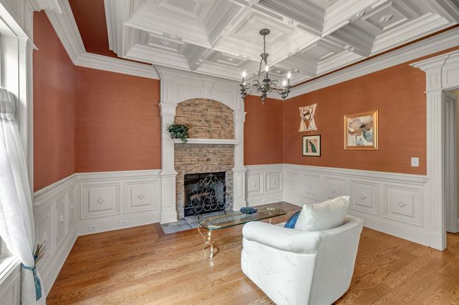 You will love this coffered ceiling with magnificent trim work. A versatile room, hearth room, den, hobby room, reading room, or a special place for guests. | Image 16