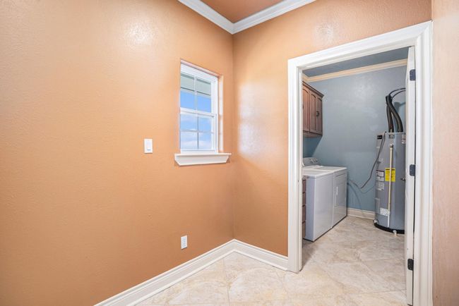 This versatile flex room can be utilized as a mudroom or for additional storage, and provides access to the laundry room. | Image 13
