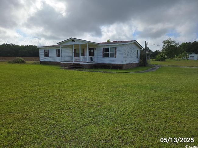 Manufactured / mobile home with covered porch and a front yard | Image 7