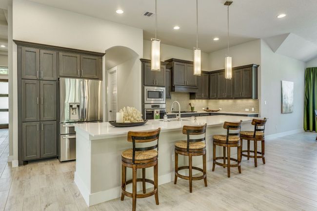 Kitchen featuring stainless steel appliances, light countertops, oversized island | Image 10