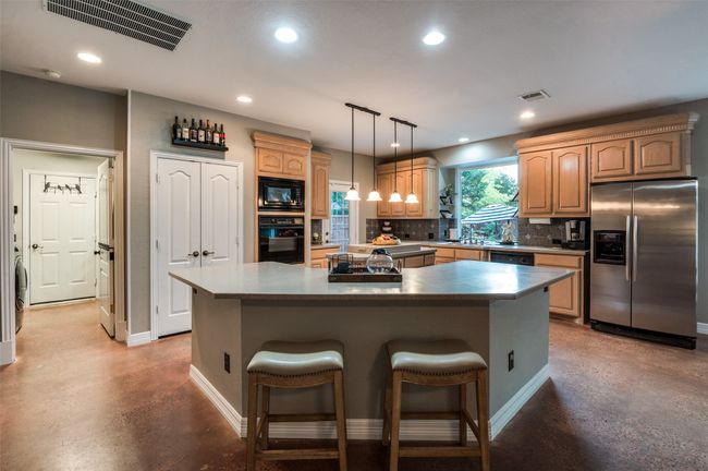 Kitchen with laundry room to the right off of kitchen | Image 21