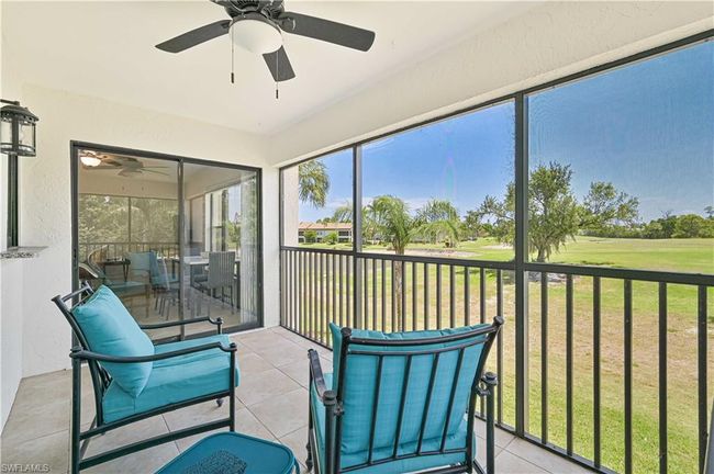 Sunroom with golf course view and a ceiling fan | Image 14