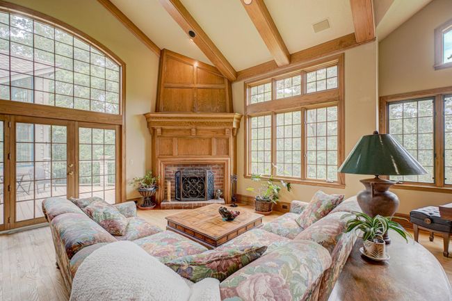 Enjoy tons of natural light in this bright and spacious great room highlighted by the gorgeous vaulted ceilings and the cozy wood burning fireplace | Image 7