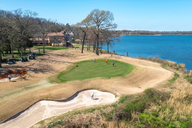 Surrounding community featuring an area to practice putting, a water view, and view of golf course | Image 38