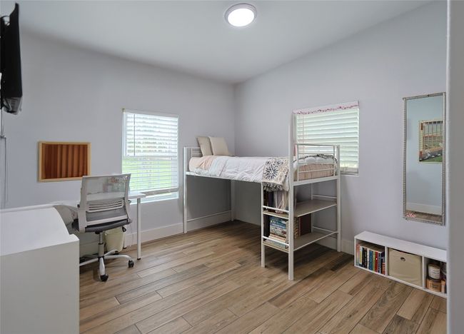 Bedroom featuring wood finished floors | Image 14
