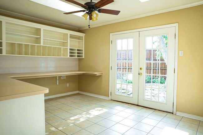 Entryway featuring french doors, crown molding, light tile patterned flooring, and a ceiling fan | Image 19