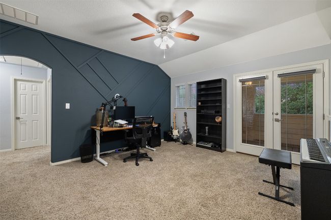 Lofted second living upstairs has a private covered balcony and access to climate controlled server room. Extensive home automation includes lights, doors, shades and security cameras. | Image 16