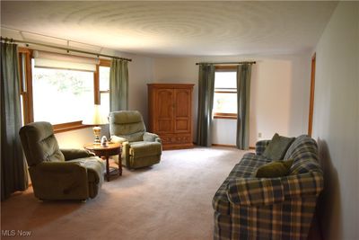 Sitting room featuring light colored carpet | Image 3