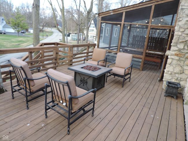 wooden deck with a fire pit | Image 33
