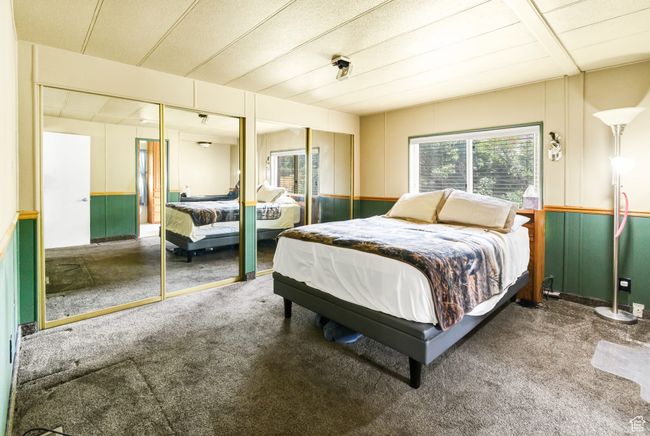 Carpeted bedroom featuring multiple windows and two closets | Image 14