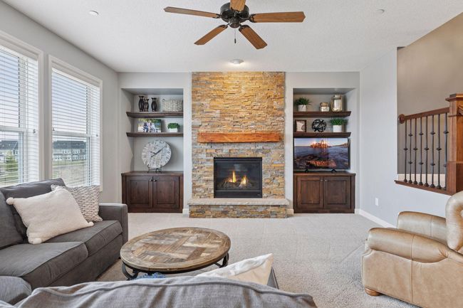 Living room features a beautiful stone fireplace and charming built-ins - 3 large windows faced to the East for long St. Croix Valley views | Image 8