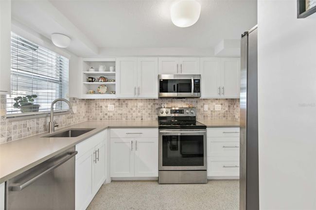 View of the kitchen from the entryway off of the hall/living room. | Image 5