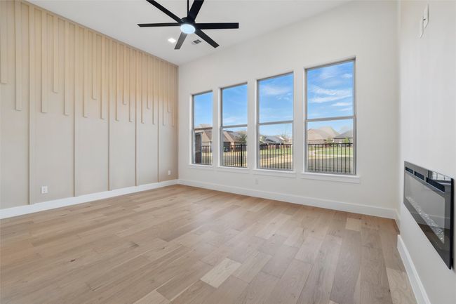 Unfurnished living room featuring baseboards, light wood-type flooring, and ceiling fan | Image 29