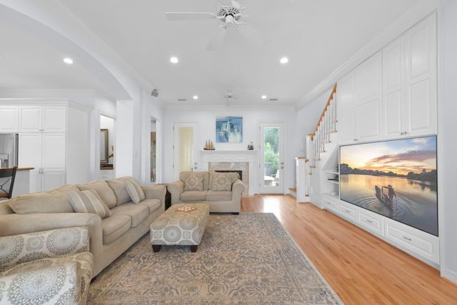 Cozy den featuring a gas fireplace and a built-in large screen TV. | Image 11