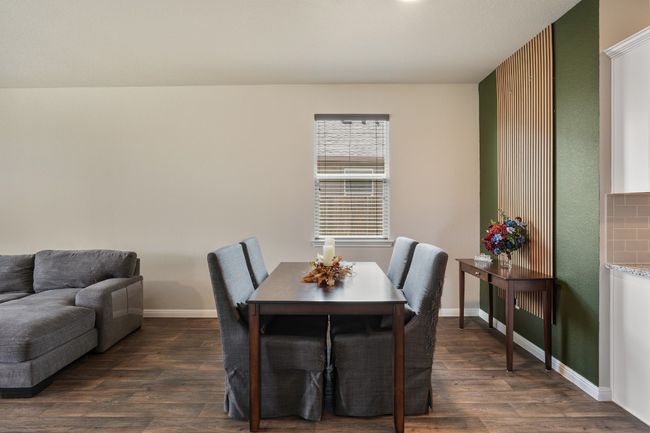 Dining space with dark wood-style flooring and baseboards | Image 11