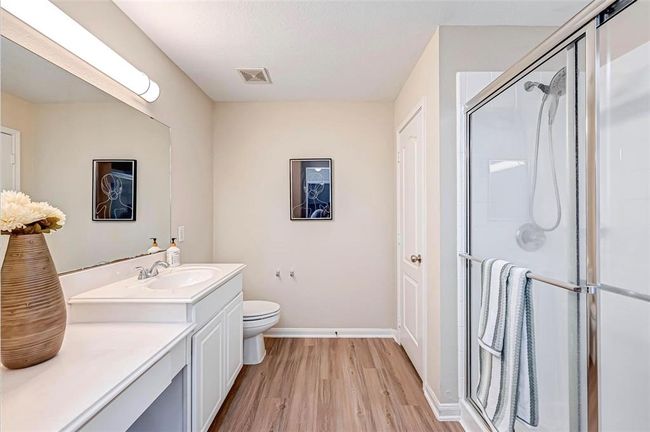 The primary bathroom features a super shower with sliding doors | Image 28