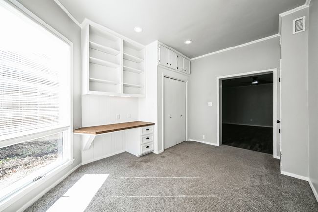 Mudroom featuring carpet, visible vents, recessed lighting, built in desk, and crown molding | Image 26