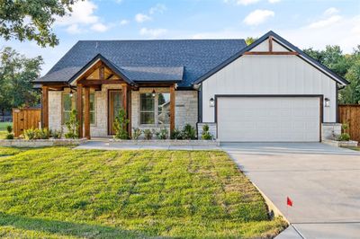 View of front of home featuring a garage and a front yard | Image 2