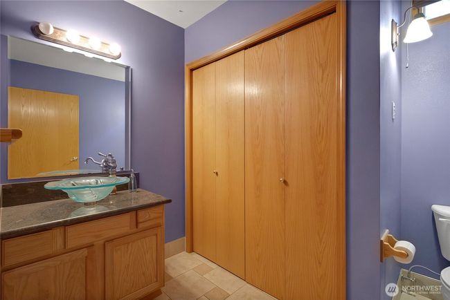 Main floor half bath - laundry behind the doors | Image 12